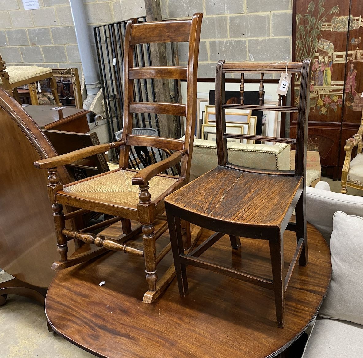 A 19th century provincial Lancaster ladder back rush seated rocking chair and a Regency elm seat dining chair